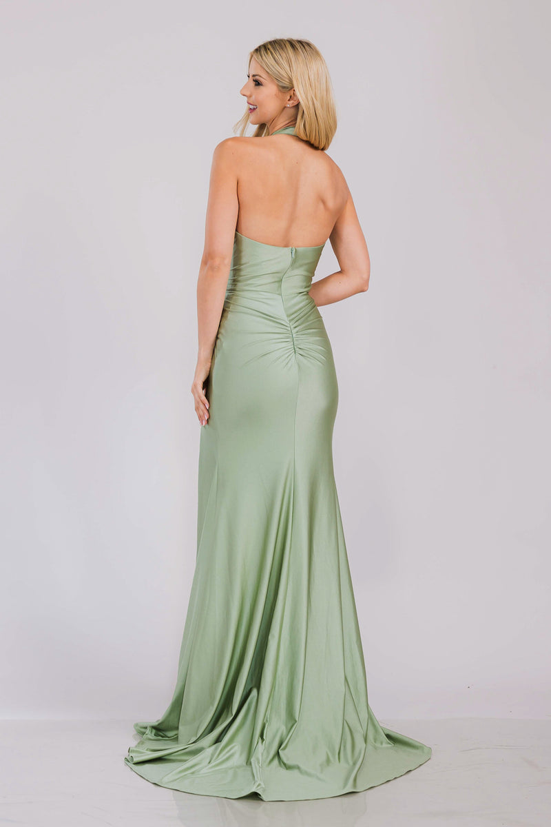 This dress features a fitted silhouette, halter neckline, skirt slit, shiny jersey fabric, and ruching along the bodice. Pair this dress with exciting earrings for you next prom or formal event look.&nbsp;

ACE 3040