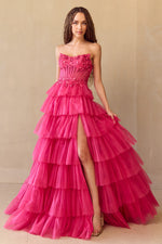 This gown features a ball gown silhouette, strapless neckline, lace up back, a sheer corset bodice with beading along the bodice, and a tiered ruffle skirt. Add a pair or simple heels for a fun prom look.&nbsp;

ACE 9053