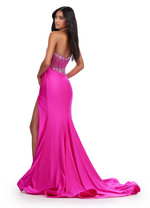 This dress features a sheer bodice with corset boning and a one-shoulder neckline detailed with crystal embroidery. The fitted silhouette has a side slit and long train and jersey fabric. This dress is vibrant and could be perfect for your next prom, pageant or formal event!

Ashley Lauren 11617