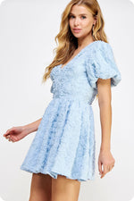 This cocktail baby doll dress features 3D floral tulle woven fabric. It features a V neckline, pom-pom lace trim throughout the front and back bodice, a plunging V back with tie closure, puff short sleeve, full lining, cinched waist, and a hidden back zipper. Style this dress to make it your own at your next homecoming or formal event.  ST D-10112-H-1