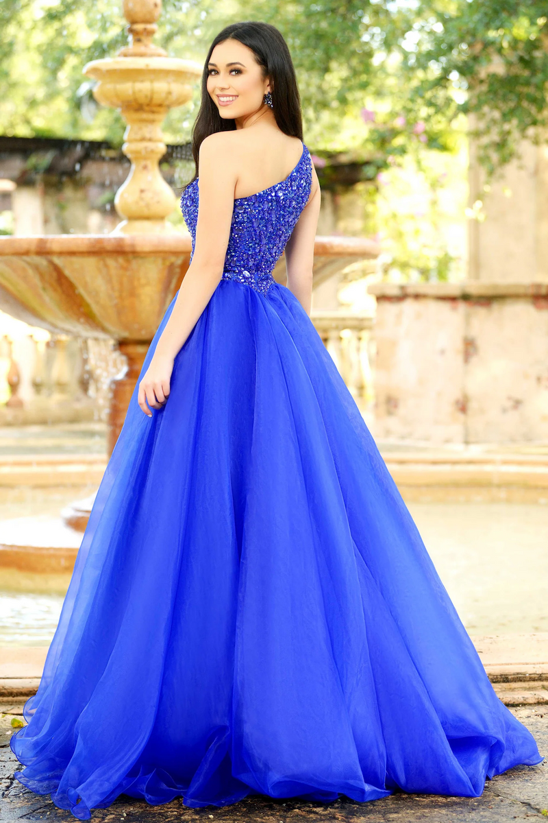 This show-stopping dress features a full ball gown silhouette, a one-shoulder neckline with a bully beaded bodice and a full skirt. Pair with statement earrings for the perfect prom or pageant look.&nbsp;

Ava Presley 37385&nbsp;