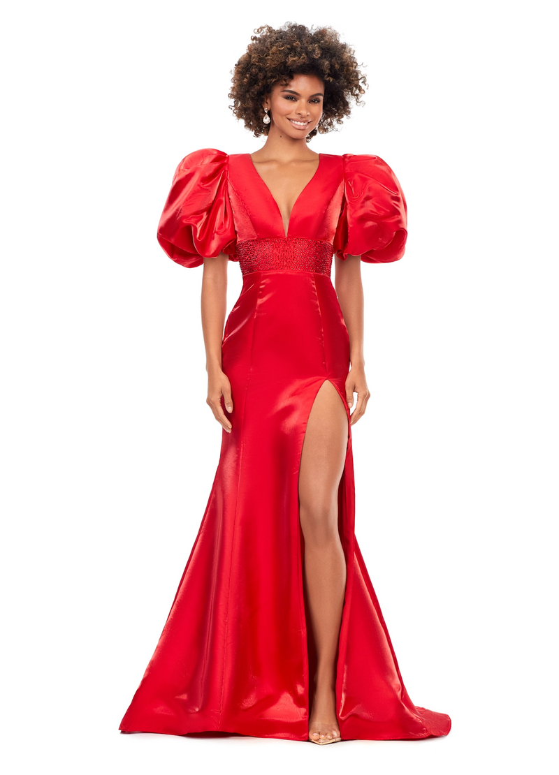 This dress features a v-neckline with oversized puff sleeves. The waistband is embellished with scattered heat set stones and is complete with a lace-up back, fitted silhouette, and a shimmer satin fabric. Style this dress to make it your own at your next prom, pageant or formal event.&nbsp;  Ashley Lauren 11379