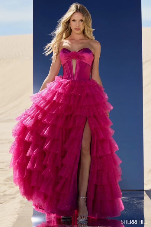 This ball gown features a strapless sweetheart neckline with a keyhole bodice, a tulle ruffle skirt and a high slit. This dress is unique and dramatic and could be just the vibe for your next prom or formal event.



Sherri Hill 56804