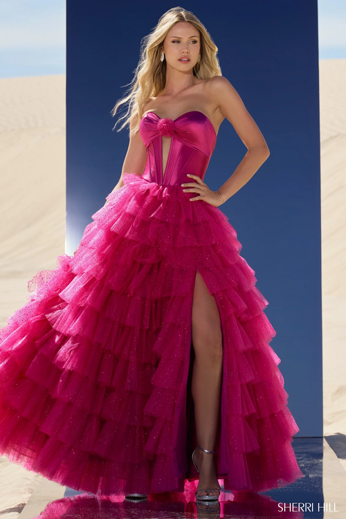 This ball gown features a strapless sweetheart neckline with a keyhole bodice, a tulle ruffle skirt and a high slit. This dress is unique and dramatic and could be just the vibe for your next prom or formal event.



Sherri Hill 56804