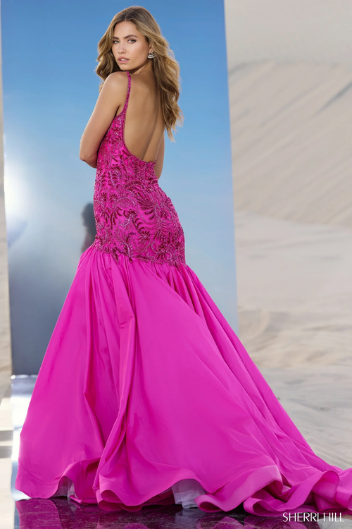 This dress features a boat neckline, spaghetti straps and an open back. The fabric is intricately beaded with a fit-and-flare taffeta skirt with a slit. Choose this unique gown for your next pageant or formal event.

Sherri Hill 56831