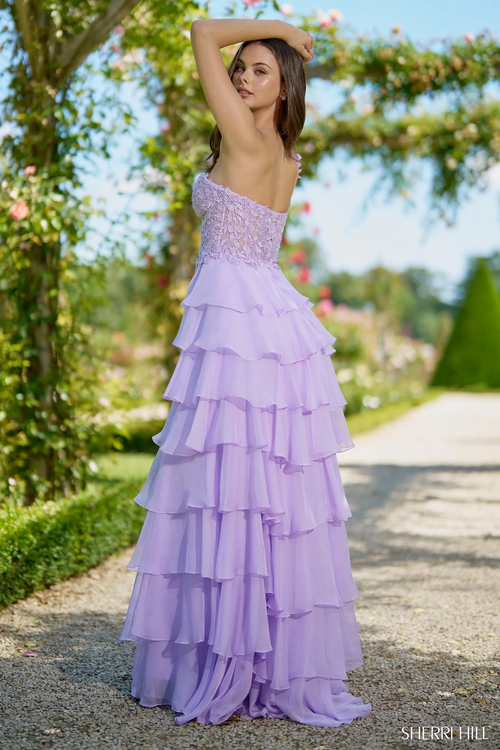 This dress features a one-shoulder neckline with a leaf lace corset bodice and a chiffon ruffle skirt with a slit. This dress is romantic and unique and could be ideal for your next prom or formal event.

Sherri Hill 56923