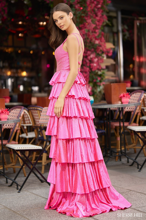 This dress features hot fix stones with ruffle tiered layers with a corset bodice, a lace up back, and a skirt slit. This dress is unique and could be perfect for your next prom or formal event!

Sherri Hill 56980