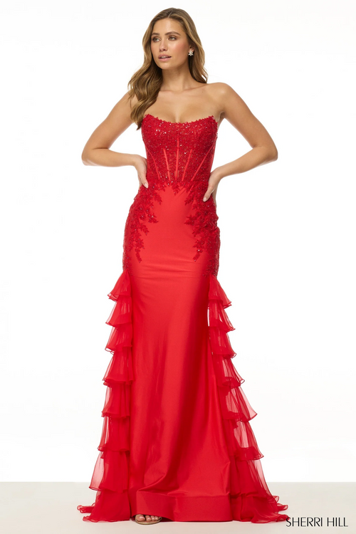 This dress features a strapless neckline with corset boning in the lace bodice. The fitted silhouette has a chiffon ruffle side skirt creating a hint of a mermaid silhouette. This dress is unique and could be perfect for your next prom or formal event.

Sherri Hill 56944