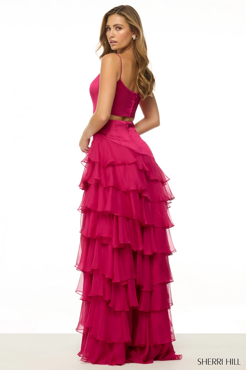 This dress features a stretch satin fabric with an open back, a drop waist, and a tiered chiffon ruffle skirt with a slit. This dress is unique and could be perfect for your next prom or formal event.

Sherri Hill 56962