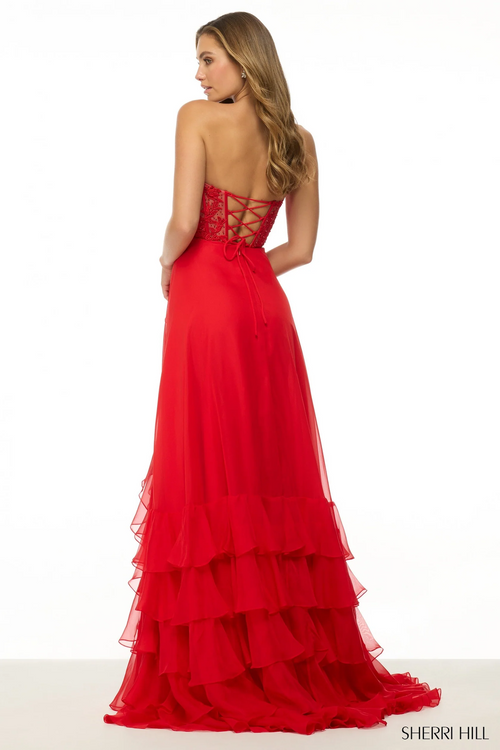 This dress features a strapless sweetheart neckline with leaf lace detailing on the bodice with a lace-up back and a chiffon ruffle skirt with a slit. This dress flows beautifully and could be perfect for your next prom or formal event.

Sherri Hill 57129