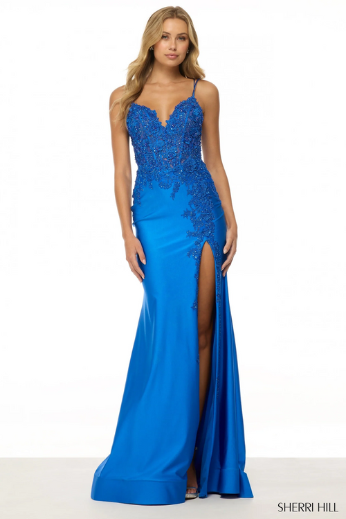 This dress features a V-neckline with spaghetti straps and a lace-up back. The bodice has corset boning and lace applique that trickles down the skirt of the gown. The fitted silhouette is complimented with a skirt slit. This may be the perfect gown for your next prom or formal event.

Sherri Hill 56448