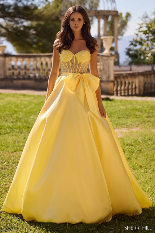 This dress features a strapless neckline with a sheer pearl bodice and a mikado skirt and a dramatic bow on the waistline. Make a statement in the dress at your next prom or formal event.

Sherri Hill 57035