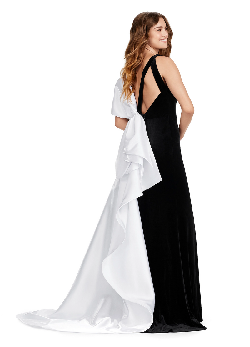 This v-neckline velvet gown features an inverted oversized satin bow with an open back, a sweep train with a slit in the skirt of the fitted silhouette. Stun away at your next prom, pageant or formal event in this unique dress!  Ashley Lauren 11527