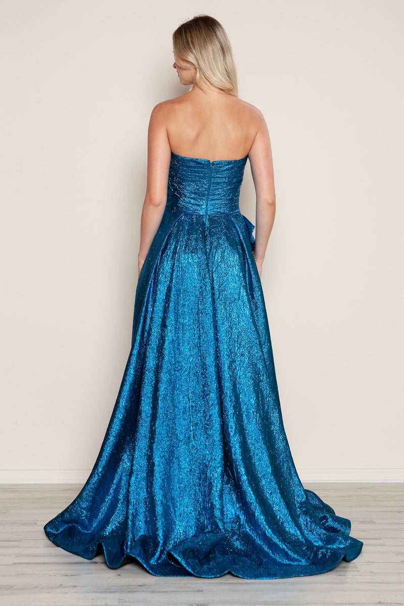 This dress features a strapless neckline with a ruched bodice that has a dramatic bow at the waistline. The metallic taffeta fabric offers an iridescent effect and the A-line silhouette photographs beautifully. This dress may be perfect for your next prom or formal event.

PY 9720