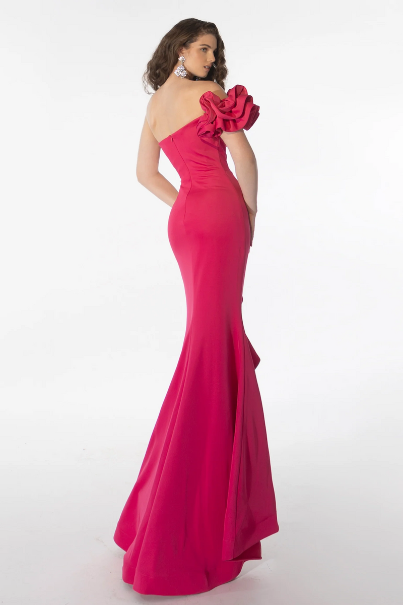 This dress features a one shoulder neckline with an embellished constructed ruffle shoulder with a fitted silhouette. The slit mirrors the shoulder with a ruffle fabric following the hemline. This gown is old Hollywood and romantic and could be just the vibe for your next prom or formal event.  ARY 39265