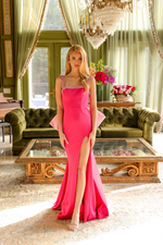 This gorgeous gown features a beaded neckline and straps, a skirt slit with large bow detail in the back, and a fitted silhouette. Perfect for your next prom, pageant or formal event!  ARY 29121