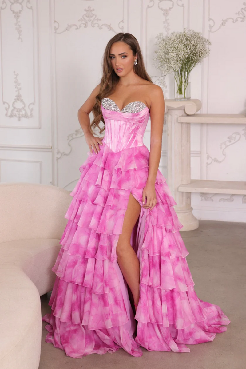 This dress features a strapless sweetheart neckline with a corset bodice that has crystal detailing on the bust. The skirt has layered ruffles which create an A-line silhouette, all in a soft watercolor print fabric. This dress is glamorous and could be ideal for your next prom or formal event.

ARY 26442