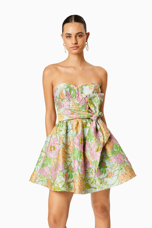 This cocktail dress features a fully boned bodice with cup detail, a flared mini skirt with a gathered waist and a separate belt tie. The large scale floral jacquard fabric is unique and could be just the vibe for your next homecoming or formal event.    ELT EC8052409