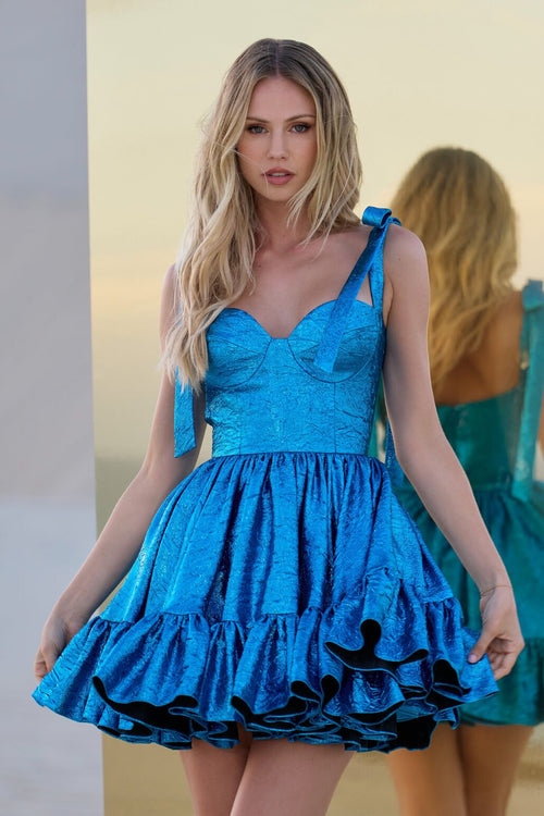 This cocktail dress features a metallic brocade fabric with a sweetheart neckline, bow sleeves and ruffle hem that creates an A-line silhouette. This dress is playful and fun and could be perfect for your next homecoming or formal event!  Sherri Hill 56507