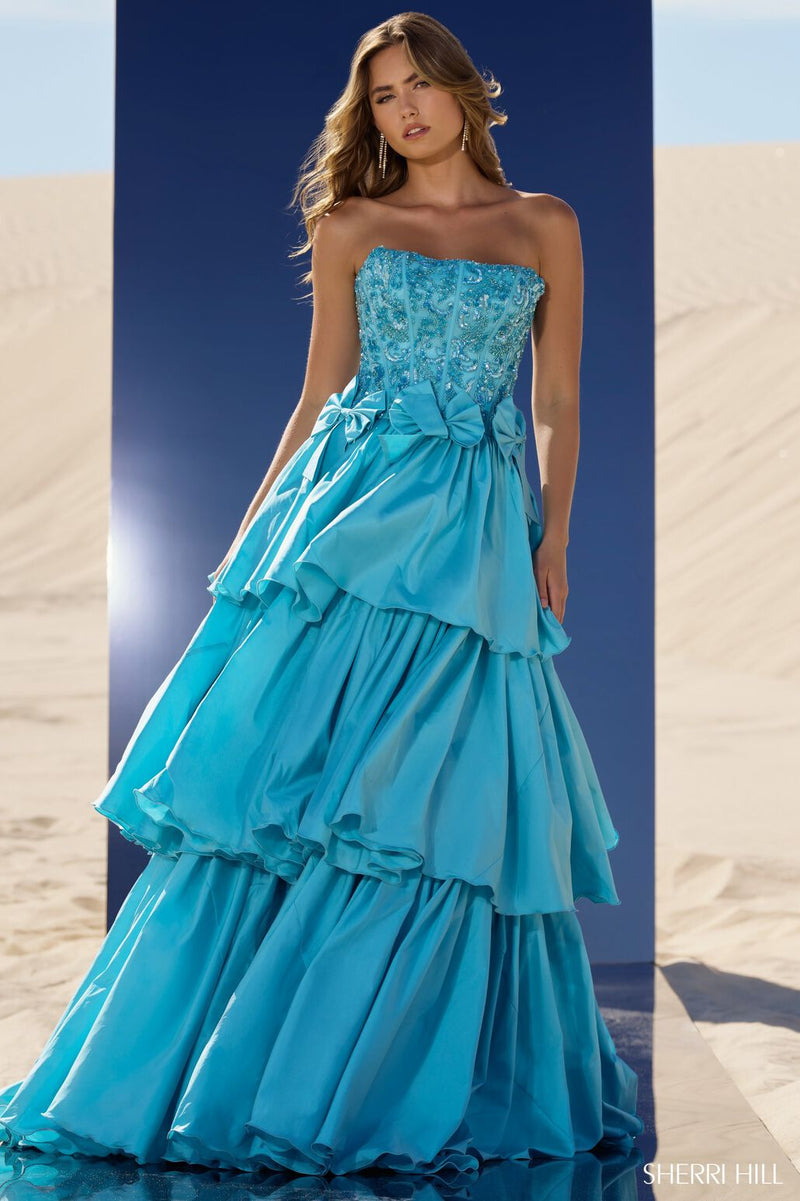 This tiered ruffle ball gown features taffeta fabric with a strapless neckline, a beaded corset bodice and bows along the waistline. This dress is unique and could be ideal for your next pageant or formal event.  Sherri Hill 56838