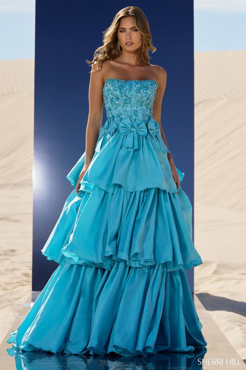 This tiered ruffle ball gown features taffeta fabric with a strapless neckline, a beaded corset bodice and bows along the waistline. This dress is unique and could be ideal for your next pageant or formal event.  Sherri Hill 56838