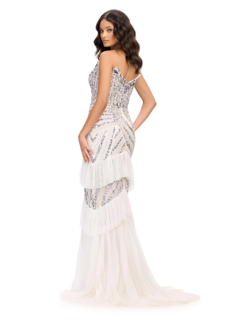 This dress features a strapless plunging v-neckline with a sequin and beaded bodice in an intricate design. This gown also has tulle layer ruffles down the&nbsp;skirt with a front slit. This is a unique and unforgettable dress for prom, pageant, or any formal event.

Ashley Lauren 11438