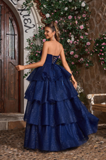 This ballgown features a strapless V-neckline with a lace-up back and an A-line silhouette with glitter tulle layered fabric. This dress is voluminous and playful and may be perfect for your next prom or formal event.

JAD J26021