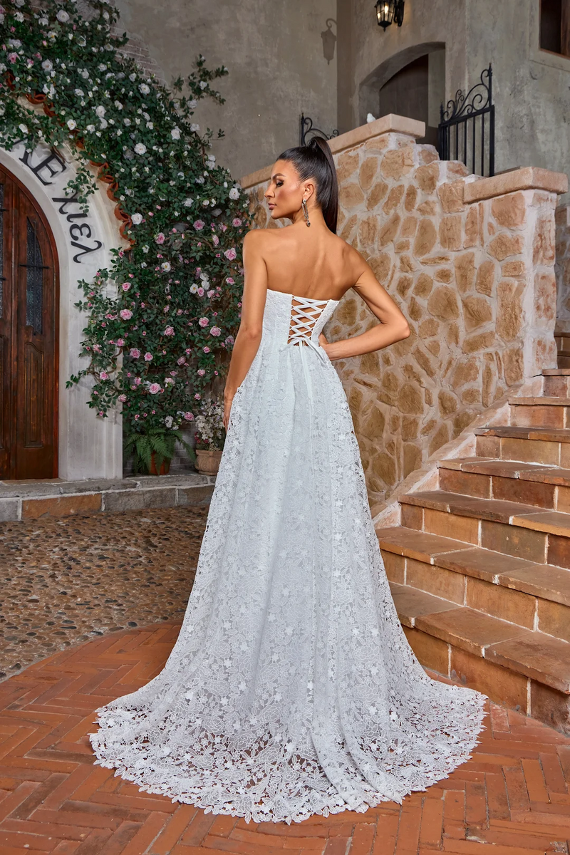 This dress features a strapless boat neckline with a lace-up back and an A-line silhouette. The fabric is a floral lace and has a boho vibe. This dress can be styled to make it your own at your next prom or formal event.

JAD J26029