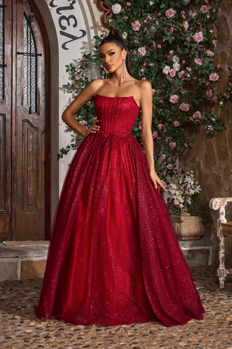 This gown features a strapless neckline with a lace-up back, a bodice with corset boning and a glitter tulle skirt A-line skirt. This fairytale dress may be ideal for your next prom or formal event.&nbsp;

JAD J26008