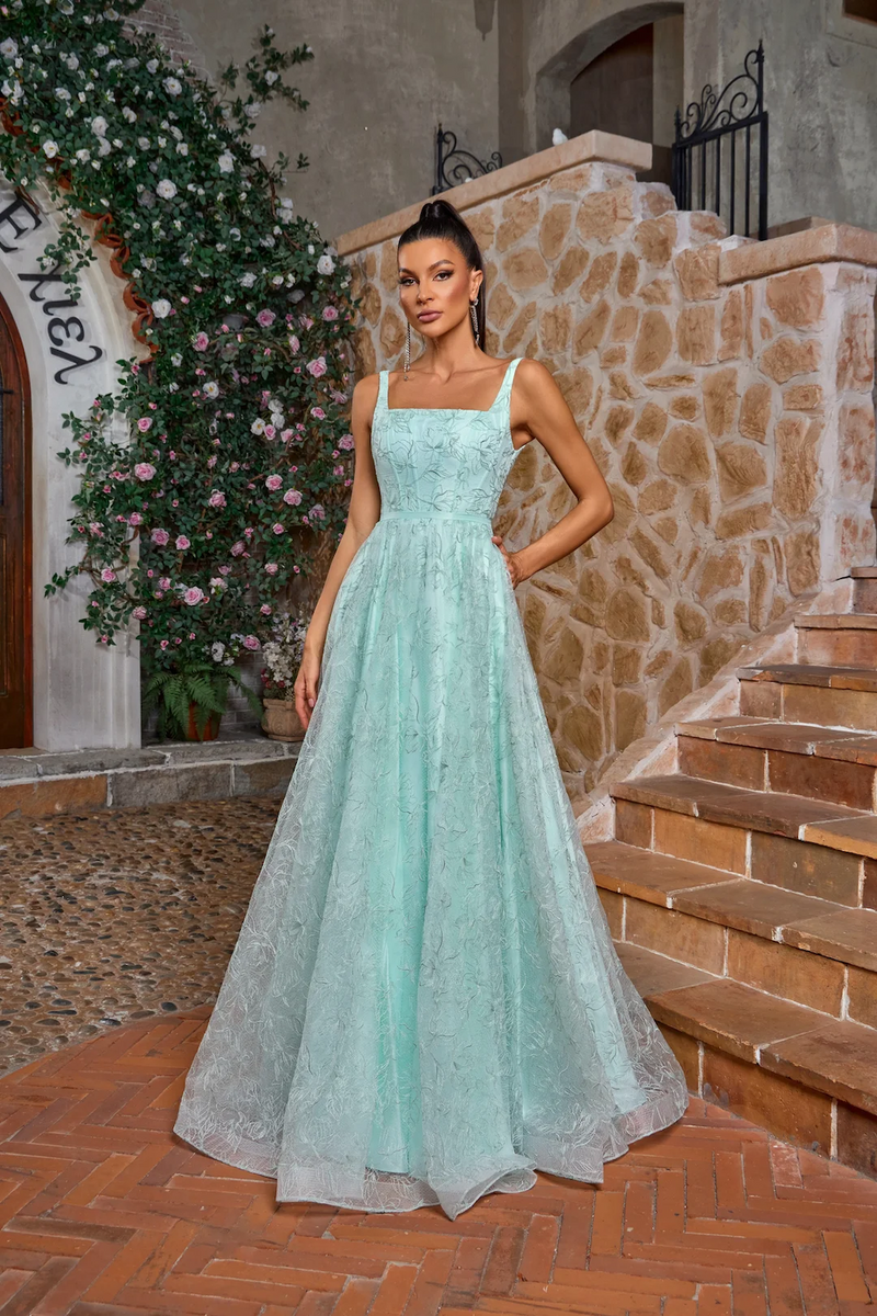 This gown features a square neckline with 1-inch straps, an A-line silhouette with a leaf and floral embroidered design. This dress is whimsical and can be styled to make it your own at your next prom or formal event.

JAD J26018