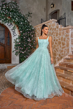 This gown features a square neckline with 1-inch straps, an A-line silhouette with a leaf and floral embroidered design. This dress is whimsical and can be styled to make it your own at your next prom or formal event.

JAD J26018