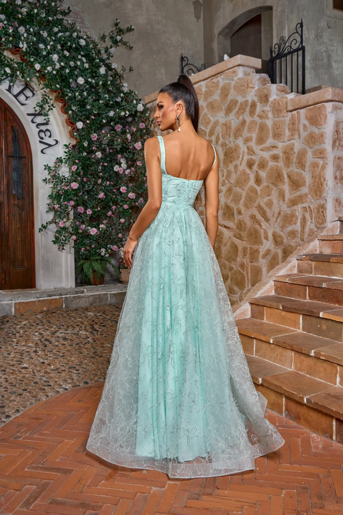 This gown features a square neckline with 1-inch straps, an A-line silhouette with a leaf and floral embroidered design. This dress is whimsical and can be styled to make it your own at your next prom or formal event.

JAD J26018