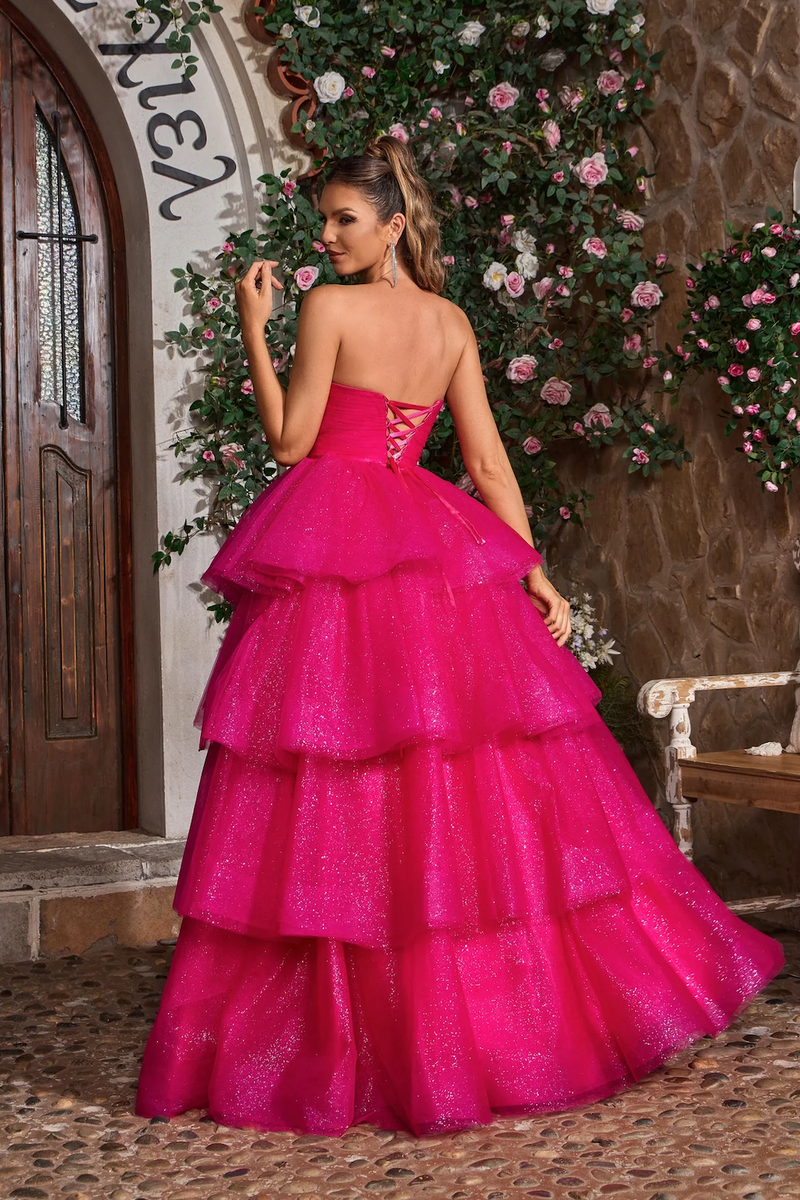 This ballgown features a strapless V-neckline with a lace-up back and an A-line silhouette with glitter tulle layered fabric. This dress is voluminous and playful and may be perfect for your next prom or formal event.

JAD J26021