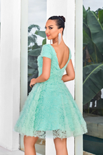 This modest cocktail dress features cap sleeves, and a square neckline with an A-line silhouette. The fabric creates 3D rosettes throughout the dress adding a unique texture. Choose this stunning dress for your next homecoming or formal event!  JAD J24088