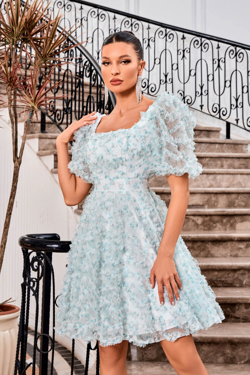 This modest cocktail dress features bell sleeves, a square neckline, and an A-line silhouette. The tulle fabric offers a 3D ruffle texture throughout the design creating an ethereal and bohemian vibe. This dress may be perfect for your next homecoming or formal event!  JAD J24094