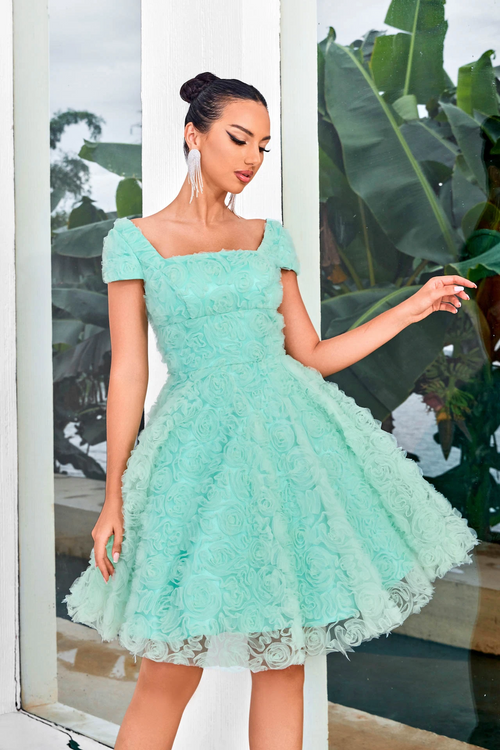 This modest cocktail dress features cap sleeves, and a square neckline with an A-line silhouette. The fabric creates 3D rosettes throughout the dress adding a unique texture. Choose this stunning dress for your next homecoming or formal event!  JAD J24088